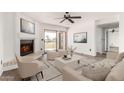 Bright living room featuring a cozy fireplace, modern furnishings, and sliding glass doors to the outside at 7061 E Broadway Rd # 48, Mesa, AZ 85208