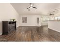 Bright, open living space with sleek wood floors, an electric fireplace, and abundant natural light at 8757 W El Caminito Dr, Peoria, AZ 85345