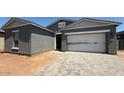 Charming single-Gathering home with a two-car garage and landscaped brick paver driveway at 11422 E Utah Ave, Mesa, AZ 85212