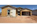This image shows an exterior view of a house under construction, revealing its framing and initial structure at 11422 E Utah Ave, Mesa, AZ 85212