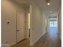 Bright hallway with wood-look flooring leading to the home's living spaces at 11422 E Utah Ave, Mesa, AZ 85212