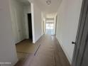 Bright hallway featuring sleek tile flooring and crisp white walls leading to the main living area at 11422 E Utah Ave, Mesa, AZ 85212