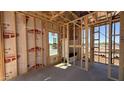 The image showcases the interior framing of a house, highlighting the structural elements and window placements at 11422 E Utah Ave, Mesa, AZ 85212