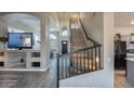 Inviting hallway showcasing an elegant staircase and views into the living and game room at 1282 W Kesler Ln, Chandler, AZ 85224