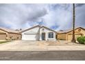 Attractive one-story house with a two-car garage and desert-style landscaping at 14623 N 90Th Ln, Peoria, AZ 85381
