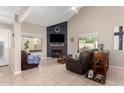 Cozy living room featuring a fireplace, comfortable seating, and natural light, perfect for relaxation at 16496 N 68Th Ave, Peoria, AZ 85382