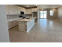 Bright kitchen with white cabinets, stainless steel appliances, and a large center island at 17016 W Cavedale Dr, Surprise, AZ 85387