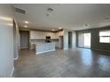 Spacious living room with tile floors, large windows, and an open floorplan at 17016 W Cavedale Dr, Surprise, AZ 85387