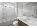 A bright bathroom features a shower-tub combo and a single sink vanity with chrome fixtures at 17767 W Getty Dr, Goodyear, AZ 85338