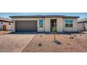 Inviting single-story home with gray garage door and low-maintenance desert landscaping at 18147 W Tanglewood Dr, Goodyear, AZ 85338