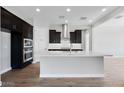 Modern kitchen with dark cabinetry, stainless steel appliances, and a bright island at 18147 W Tanglewood Dr, Goodyear, AZ 85338