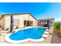 Inviting backyard pool features a clean design with outdoor seating and an adjacent patio perfect for entertaining or relaxing at 18543 W Denton Ave, Litchfield Park, AZ 85340