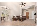 Inviting living room showcasing tile flooring, high ceilings, and an archway to another room at 20802 N Grayhawk Dr # 1005, Scottsdale, AZ 85255