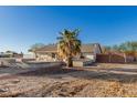 The exterior back of the home with desert landscaping and outdoor sitting, ideal for enjoying the serene surroundings at 22324 W Magnolia St, Buckeye, AZ 85326