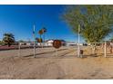 Gated property entrance with desert landscaping provides security and privacy for this beautiful home at 22324 W Magnolia St, Buckeye, AZ 85326