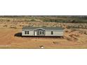 New build home featuring a gray exterior, complementing the tranquil desert landscape at 23139 W Duane Ln, Wittmann, AZ 85361