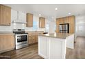 Bright kitchen with wood cabinets, stainless steel appliances, and a functional island at 23139 W Duane Ln, Wittmann, AZ 85361
