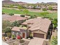 Aerial view of a well-maintained house and golf course with mature trees and landscaping at 27688 N 125Th Dr, Peoria, AZ 85383