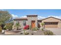 Charming front exterior with stone accents, desert landscaping, and a cozy design at 27688 N 125Th Dr, Peoria, AZ 85383