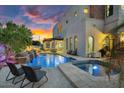 Relaxing backyard pool and spa with waterfall features and comfortable lounge seating at 3675 N 59Th Pl, Phoenix, AZ 85018