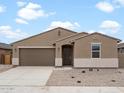 Inviting single-story home with a two-car garage, neutral stucco, and minimalist landscaping at 37215 W Patterson St, Maricopa, AZ 85138