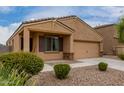 Charming single-story home with neutral stucco, low-maintenance landscaping, and attached two-car garage at 37384 W Prado St, Maricopa, AZ 85138