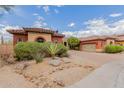 Beautiful desert-landscaped home with a red-tiled roof, colorful exterior, and an attached garage at 3816 E Expedition Way, Phoenix, AZ 85050