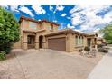 Two-story home featuring a tile roof, an attached garage, and a well-manicured front yard at 3940 E Geronimo St, Gilbert, AZ 85295