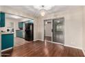 Open dining area with wood floors, a chandelier and sliding door access to the backyard and bright spaces at 4158 E Crescent Ave, Mesa, AZ 85206