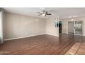 Bright living room featuring a ceiling fan, wood floors and access to the backyard via sliding glass doors at 4158 E Crescent Ave, Mesa, AZ 85206