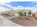 Charming single-story home with a brick driveway, desert landscaping, and barrel accents at 5312 W Hardtack Trl, Laveen, AZ 85339