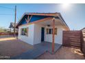 Exterior of house with blue gable, rustic wood supports, shutters and a fenced in yard at 576 N Pasadena --, Mesa, AZ 85201