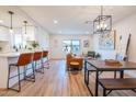 Open-concept living space with hardwood floors, connecting kitchen, living, and dining areas, great for modern living at 576 N Pasadena --, Mesa, AZ 85201