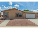 Charming single-story home with a two-car garage and low-maintenance rock landscaping at 5901 E Leonora St, Mesa, AZ 85215
