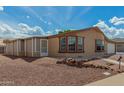 Charming one-story home with a screened-in porch and low-maintenance front yard landscaping at 5901 E Leonora St, Mesa, AZ 85215