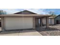 Charming single-story home featuring a two-car garage and covered front porch at 6231 W Zoe Ella Way, Glendale, AZ 85306