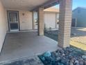 Inviting covered front porch with decorative rock landscaping and view of front yard at 6231 W Zoe Ella Way, Glendale, AZ 85306