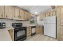 A well-lit kitchen featuring wood cabinets, black appliances, and durable countertops at 8103 E Southern Ave # 268, Mesa, AZ 85209