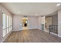 Open living room with wood floors, plantation shutters, and access to kitchen and entry foyer at , Glendale, AZ 85302