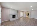 Spacious living room featuring a modern fireplace, wood floors, and access to the kitchen at , Glendale, AZ 85302