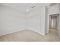 Bright bedroom with neutral carpet, a closet with sliding doors, and white walls at 17761 W Getty Dr, Goodyear, AZ 85338