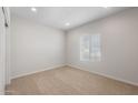 Inviting carpeted bedroom filled with natural light from window at 17776 W Getty Dr, Goodyear, AZ 85338