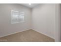Bright bedroom featuring a window and comfortable neutral carpet at 17776 W Getty Dr, Goodyear, AZ 85338