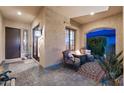 Charming outdoor porch featuring stone floors, comfortable seating, and a cozy fire pit at 1829 N Atwood --, Mesa, AZ 85207