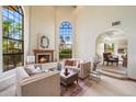 Bright living room with a fireplace and large windows that offer a view of the exterior at 1905 N Calle Maderas --, Mesa, AZ 85213