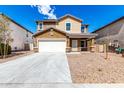Two-story home featuring a driveway, two-car garage, and low maintenance front yard landscaping at 20116 W Monroe St, Buckeye, AZ 85326