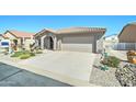Inviting single-story home featuring a well-manicured front yard with gravel and a two-car attached garage at 2101 S Meridian Rd # 146, Apache Junction, AZ 85120