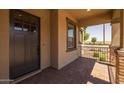 Inviting front porch with brick accents and wrought iron railing, perfect for relaxing at 23162 E Canary Way, Queen Creek, AZ 85142
