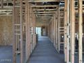 Unfinished living room displaying exposed framework, open concept design, and modern construction layout at 24083 W Bowker St, Buckeye, AZ 85326