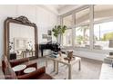Elegant living room featuring a piano, modern furniture, large window with natural light, and hardwood floors at 2505 E Lehi Rd # 16, Mesa, AZ 85213